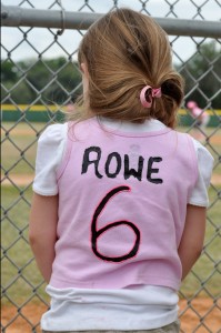 Reagan Rowe, Ricky's youngest daughter, rooting on her sister and daddy as they play softball.